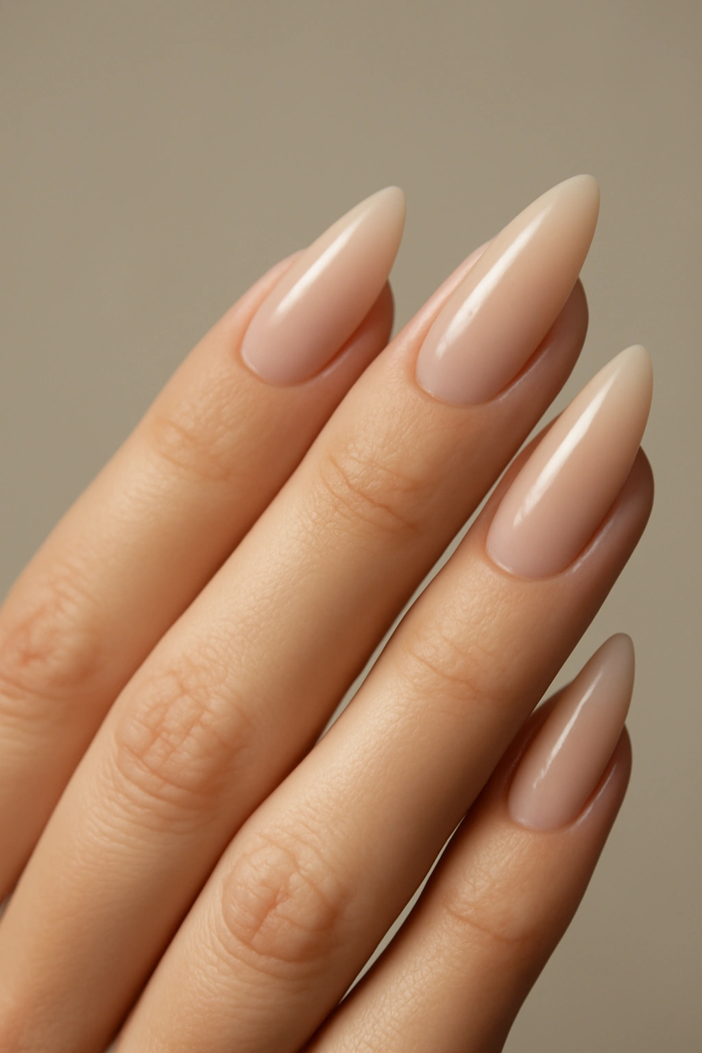 Close-up of almond-shaped nails with a soft point and length