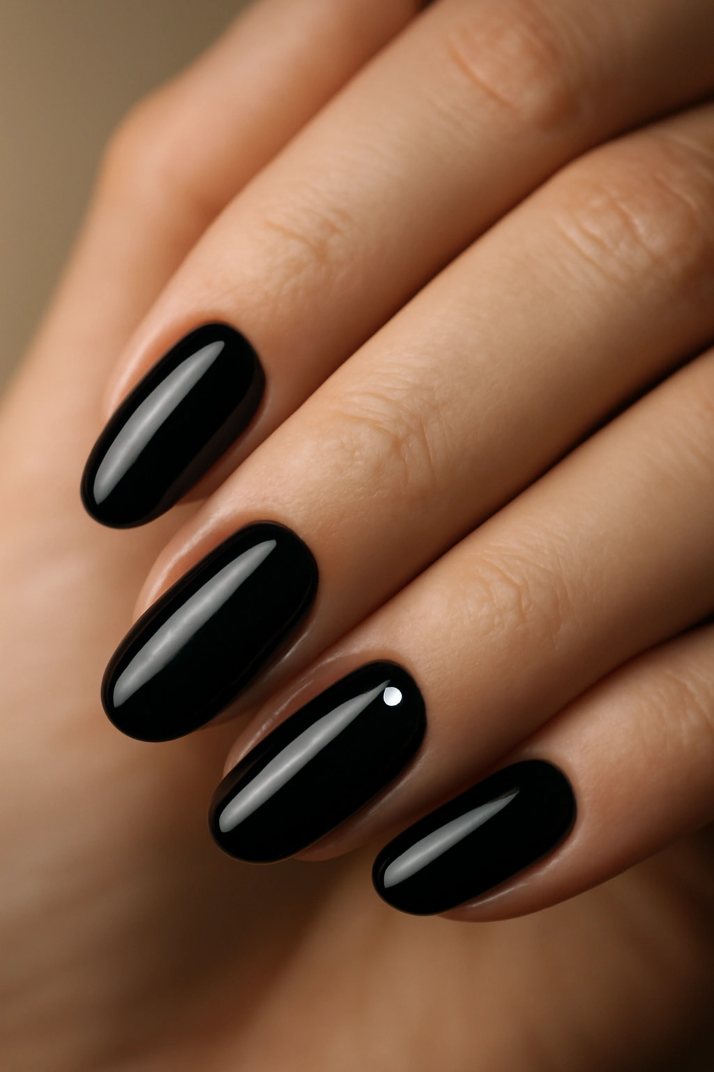 Close-up of black nails with glossy finish and subtle twist