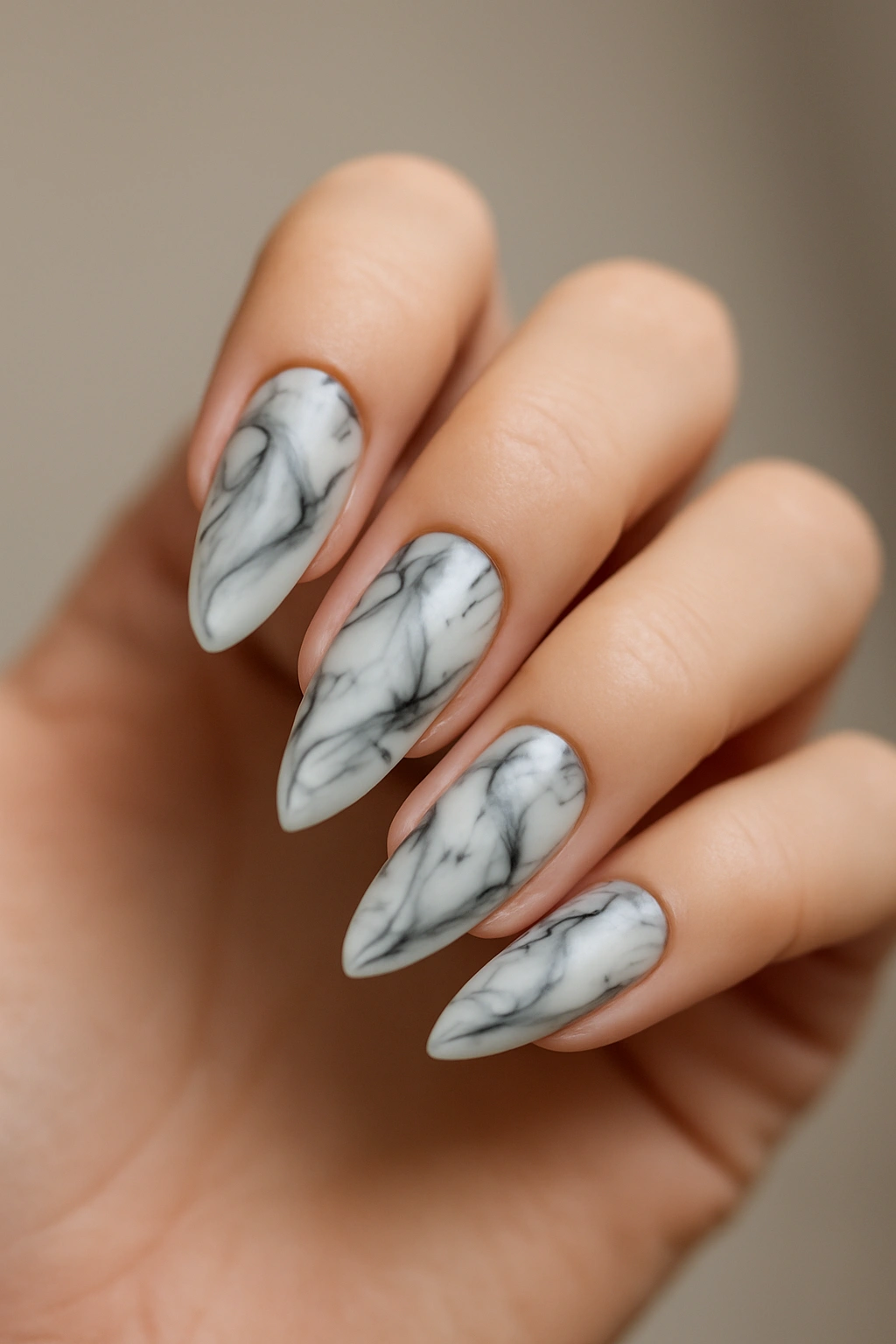 Close-up of Marble Almond Nails with black and white marble pattern