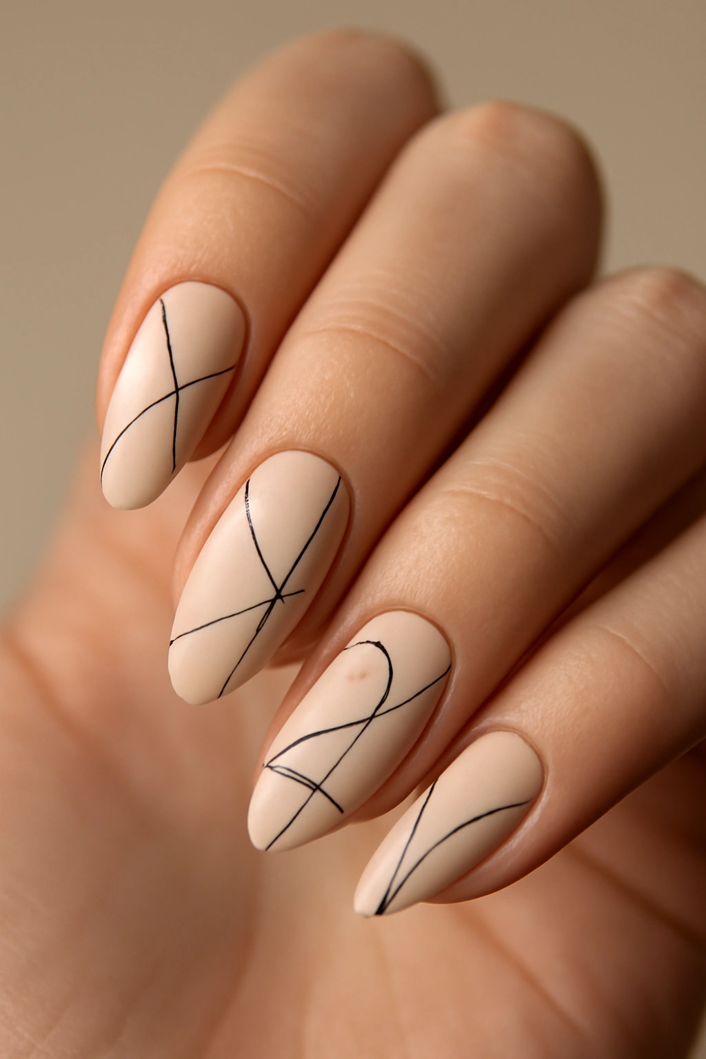 Close-up of Minimalist Line Art Almond Nails with fine black lines