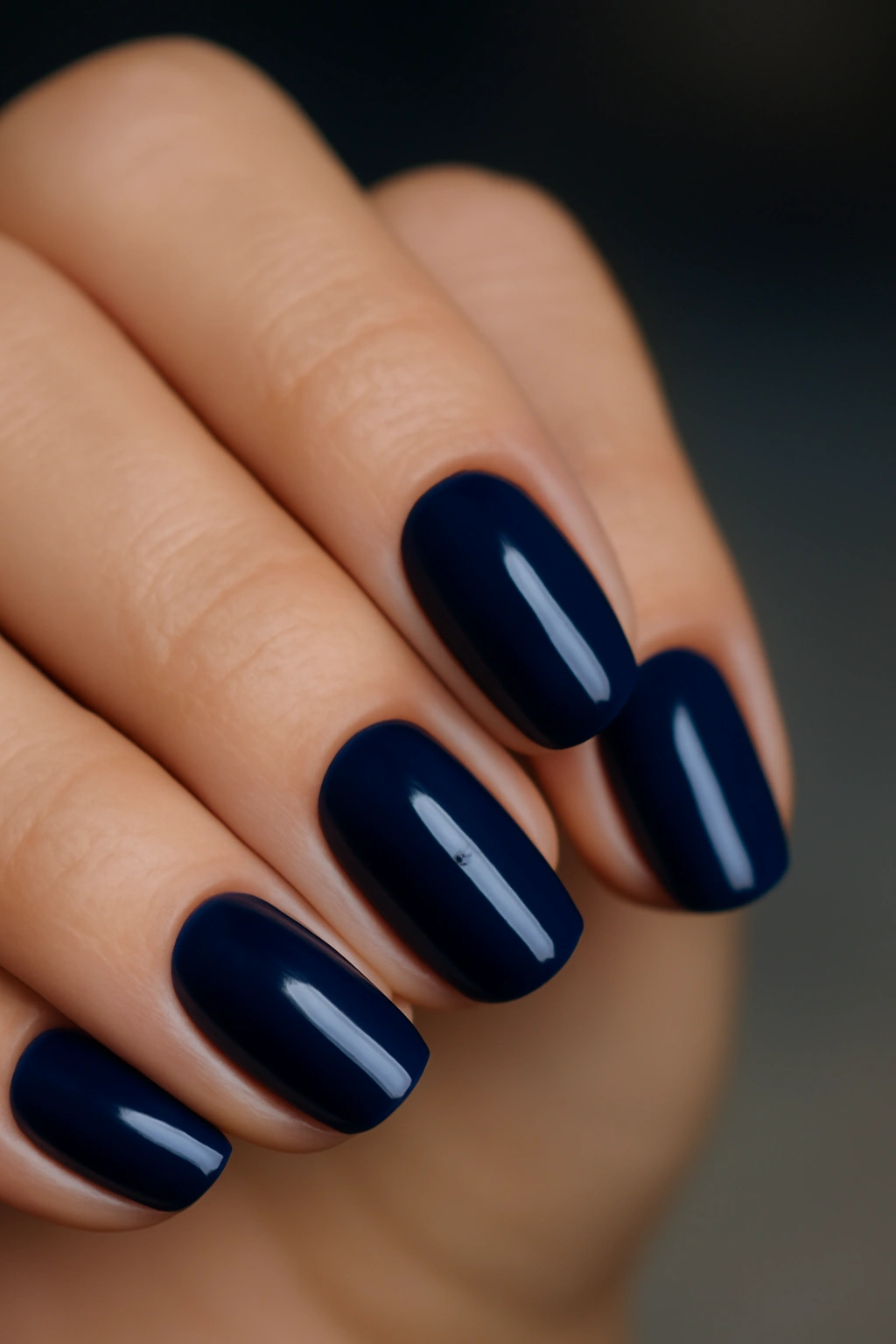 Close-up of navy blue nails with rich color and glossy finish