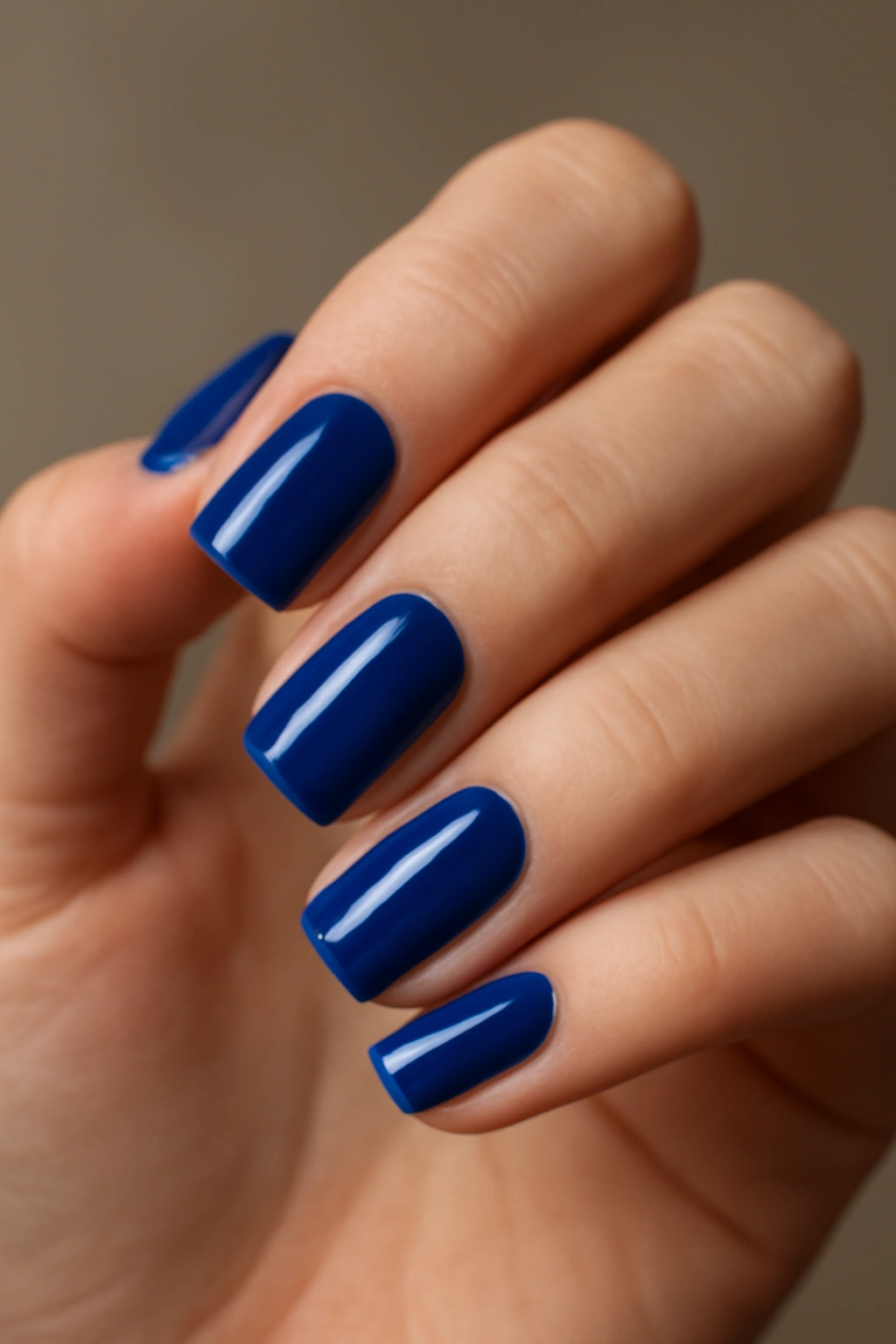 Close-up of royal blue nails on a clean hand
