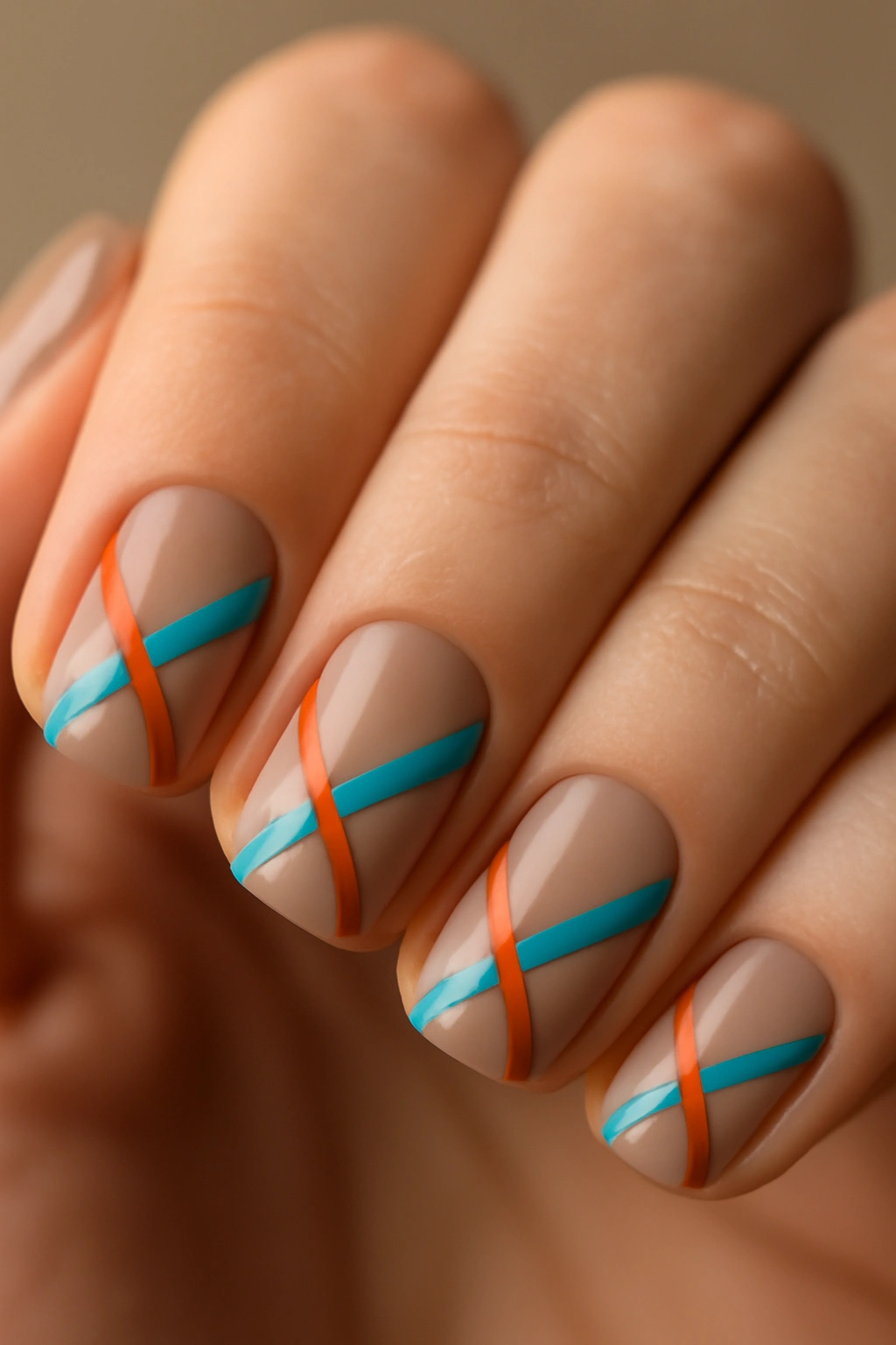 Close-up of nails with geometric stripe patterns created by tape
