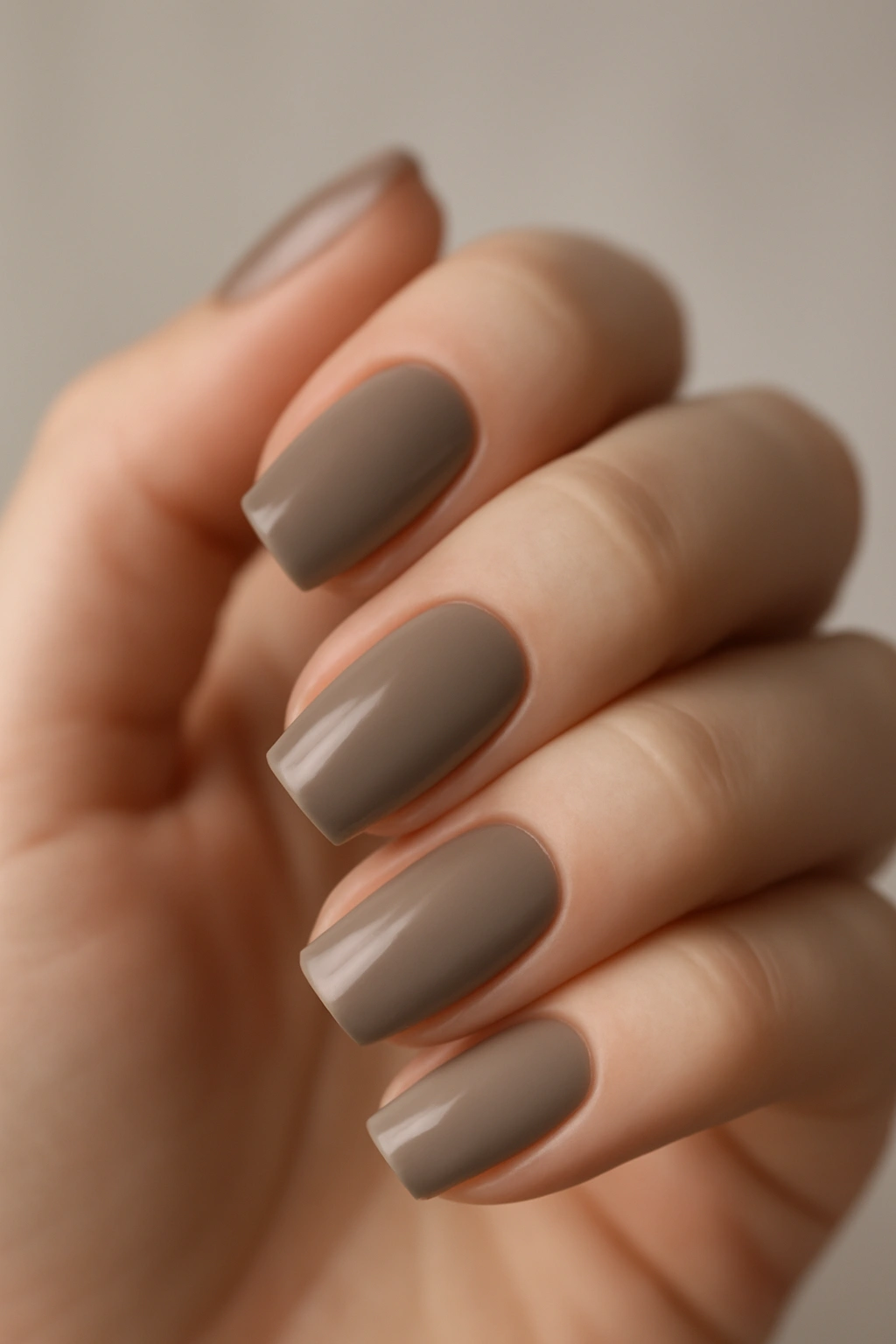 Close-up of taupe nails in a grey-brown neutral manicure